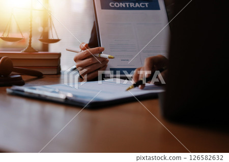 Judge gavel with Justice lawyers having team meeting at law firm background. Concepts of Law and Legal services. 126582632