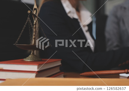 Judge gavel with Justice lawyers having team meeting at law firm background. Concepts of Law and Legal services. Judge gavel with Justice lawyers having team meeting at law firm background. Concepts of Law and Legal services. 126582637