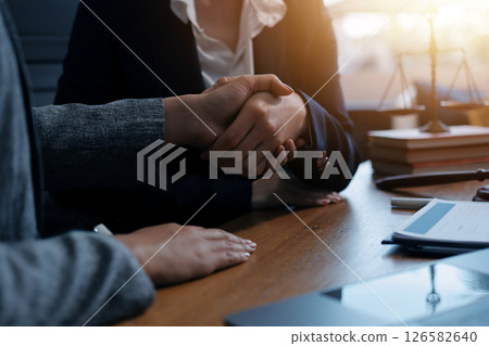Judge gavel with Justice lawyers having team meeting at law firm background. Concepts of Law and Legal services. 126582640