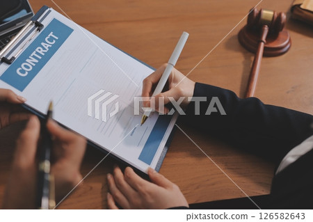 Judge gavel with Justice lawyers having team meeting at law firm background. Concepts of Law and Legal services. 126582643