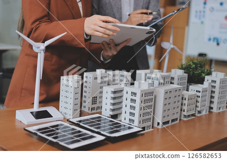 Discussion among businesspeople on the latest developments in solar cell panel technology and Solar Energy Environment city Concept. Discussion among businesspeople on the latest developments in solar cell panel technology and Solar Energy Environment city Concept. 126582653