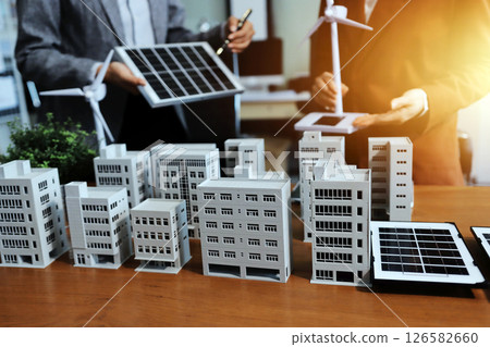 Discussion among businesspeople on the latest developments in solar cell panel technology and Solar Energy Environment city Concept. 126582660