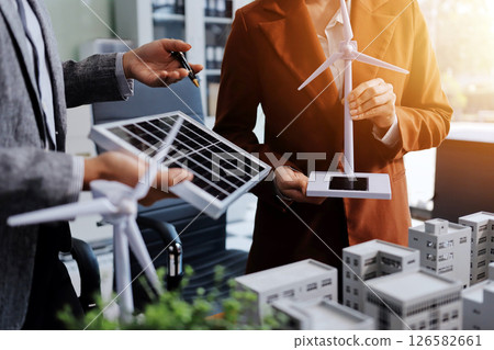 Discussion among businesspeople on the latest developments in solar cell panel technology and Solar Energy Environment city Concept. Discussion among businesspeople on the latest developments in solar cell panel technology and Solar Energy Environment city Concept. 126582661