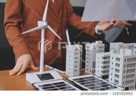Discussion among businesspeople on the latest developments in solar cell panel technology and Solar Energy Environment city Concept. 126582662