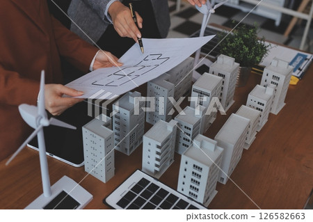 Discussion among businesspeople on the latest developments in solar cell panel technology and Solar Energy Environment city Concept. 126582663