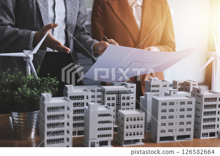 Discussion among businesspeople on the latest developments in solar cell panel technology and Solar Energy Environment city Concept. 126582664