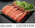 King crab shabu-shabu (raw portions) is served on a black plate. The background is black. 126583408
