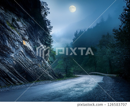 Moon, fog and cliffs in the mountains and an old road - AI generated image 126583707