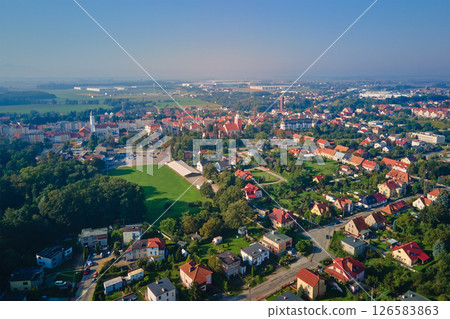 Aerial view of European small town. Drone view of urban landscape with residential building, green parks and city streets 126583863