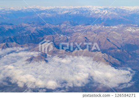 A beautiful snow-capped view of the majestic Alps from an airplane 126584271