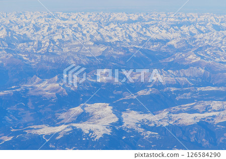 A beautiful snow-capped view of the majestic Alps from an airplane 126584290