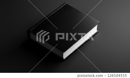 An elegant black book lying on a monochrome surface and displaying a minimalist design. Mockup 126584555
