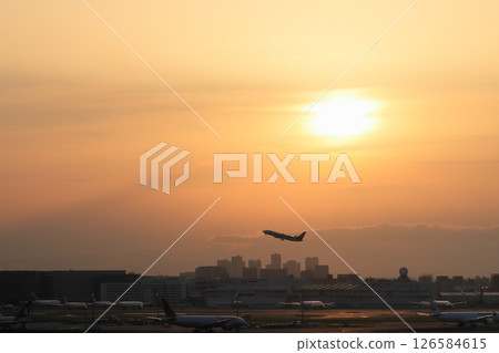 Passenger plane taking off against the backdrop of a sunset Silhouette of a passenger plane taking off 126584615