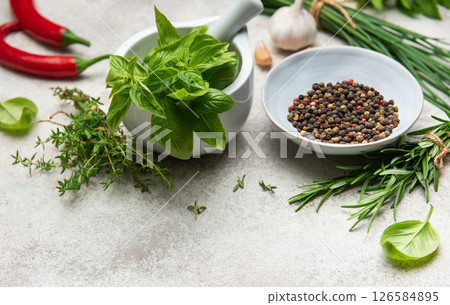 Fresh herbs and spices creating culinary masterpiece on table 126584895