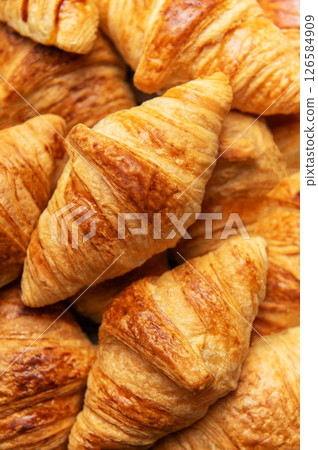 Freshly baked croissants forming an appetising background for french breakfast 126584909