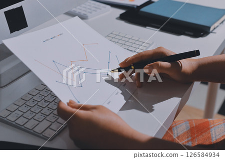 Expert woman asian female people review data number costing managerial account prepare monthly actual cost variance report at tax audit office. ESG sheet budget control ERP process service project. 126584934