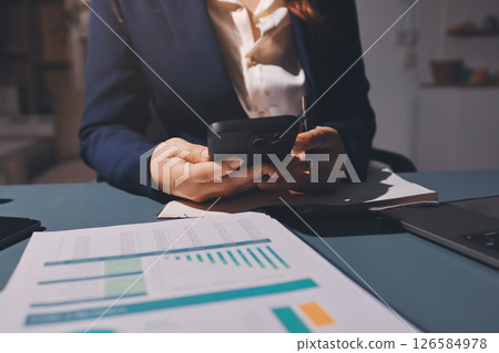 Expert woman asian female people review data number costing managerial account prepare monthly actual cost variance report at tax audit office. ESG sheet budget control ERP process service project. 126584978