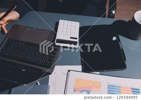 Expert woman asian female people review data number costing managerial account prepare monthly actual cost variance report at tax audit office. ESG sheet budget control ERP process service project. 126584995