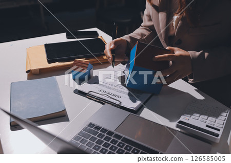 Female Real Estate Broker presenting and advised to model home and building project detail in the office, sign purchase sales contract, agreements concerned mortgage loan offer and insurance. 126585005