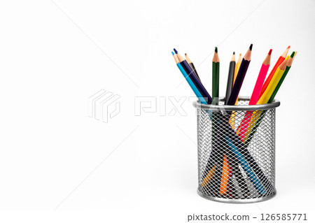 Colored pencils stand on a white background on the right. Banner on school theme 126585771