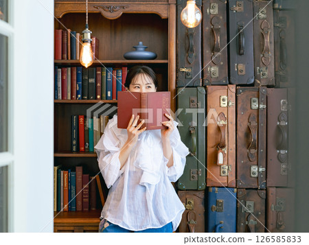 Portrait of a woman reading a book 126585833