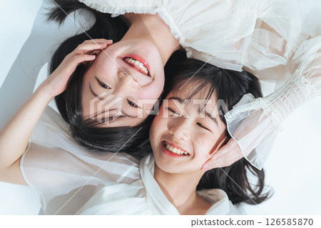 Portrait of sisters hugging each other 126585870