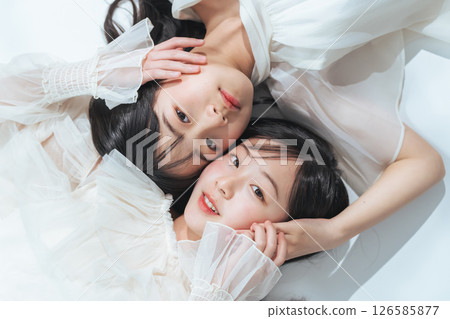 Portrait of sisters hugging each other Portrait of sisters hugging each other 126585877