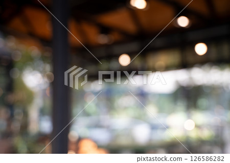 Blur cafe coffee with bokeh background blurred image of outdoor cafe or restaurant with warm lighting and wooden ceiling, creating cozy Blur cafe coffee with bokeh background blurred image of outdoor cafe or restaurant with warm lighting and wooden ceiling, creating cozy 126586282