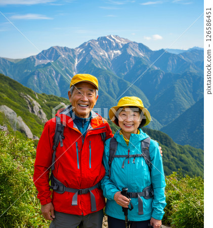 An energetic senior couple climbing a mountain An energetic senior couple climbing a mountain 126586451
