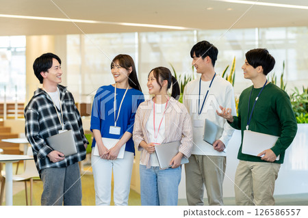 Young engineers working in an office. Photo courtesy of Denpa Gakuen, Tokyo Electronics College. 126586557