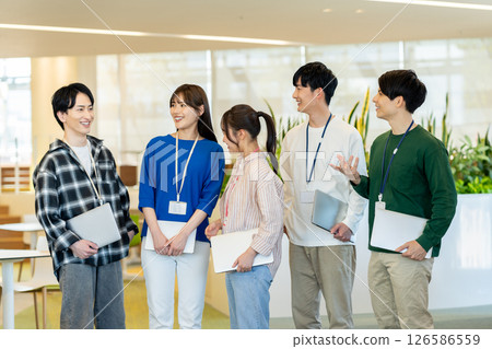 Young engineers working in an office. Photo courtesy of Denpa Gakuen, Tokyo Electronics College. 126586559