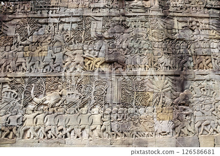 Wall carving with depicting troops, soldiers, military leaders on elephants in Prasat Bayon Temple, Angkor Wat complex, Siem Reap, Cambodia. Bas-relief - King of Angkor Jayavarman VII with his army 126586681