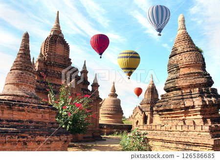 Balloon flight, famous tourist attraction of Bagan, Myanmar. Air balloons and ancient stupas in archaeological zone, Bagan, Burma. Topic of vacation, travel, trip abroad on vacation, cruises and tours 126586685