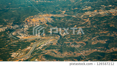 View From Airplane Window On Suburb Of Chengdu, China. Mountainous Landscape Of China. Porthole View Or Called Bull's-eye Window. Discover China. Chengdu Is Capital City Of Chinese Province Of Sichuan View From Airplane Window On Suburb Of Chengdu, China. Mountainous Landscape Of China. Porthole View Or Called Bull's-eye Window. Discover China. Chengdu Is Capital City Of Chinese Province Of Sichuan 126587212