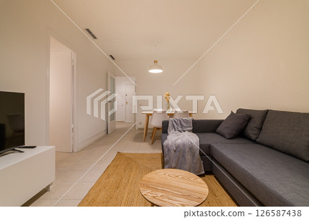 Wide view from the living room showing the dining area and entrance in a modern minimalist apartment 126587438