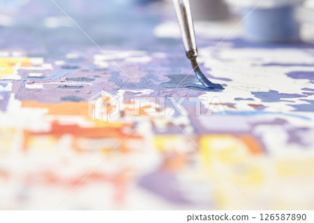 Abstract painting in progress with focus on paintbrush and colorful details 126587890