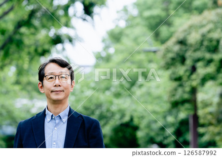 Middle-aged man walking outdoors 126587992