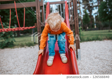 Little boy getting ready to slide 126588840