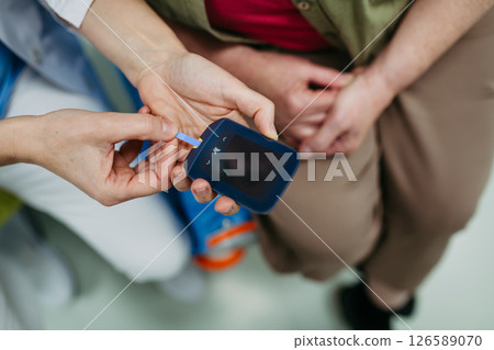 Nurse preparing glucose meter for blood sugar test 126589070