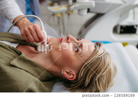 Female patient undergoing thyroid ultrasound examination Female patient undergoing thyroid ultrasound examination 126589189