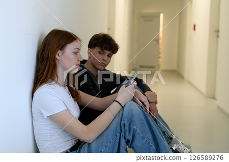 Boy and girl waiting in hospital waiting room for medical examination. 126589276