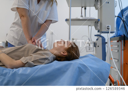 Doctors performing CPR on teenage patient in critical condition Doctors performing CPR on teenage patient in critical condition 126589346
