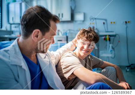 Physician supporting nervous teenage patient during mental health check. Physician supporting nervous teenage patient during mental health check. 126589367