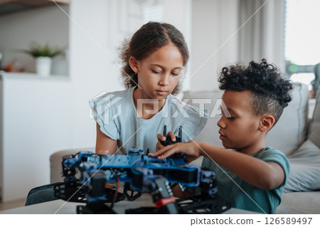 Kids playing with drone at home. 126589497