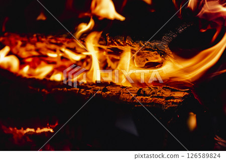 Fire in a fireplace in the living room 126589824