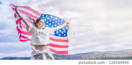 Celebrating independence day us in 4th july with a young american woman waving the flag, Freedom and copy space right place outdoors Celebrating independence day us in 4th july with a young american woman waving the flag, Freedom and copy space right place outdoors 126589940