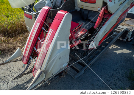 Unloading the combine from the truck 126590883