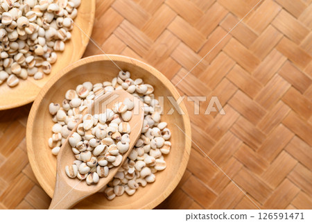 Dried Job's tears or adlay millet seeds in wooden bowl with scoop, Food ingredient, Top view 126591471