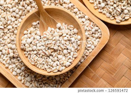 Dried Job's tears or adlay millet seeds in wooden bowl with spoon, Food ingredient, Top view 126591472