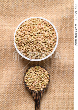 Organic buckwheat seed in bowl and spoon, Food ingredient, Top view 126591485